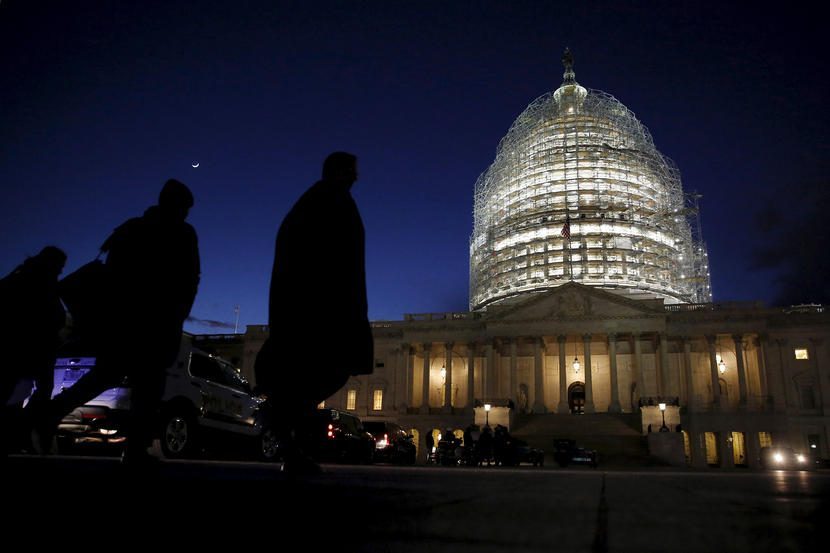 People walk past the U.S. Capitol dome in the hours before Obama delivers the State of the Union address to a joint session of Congress in Washington